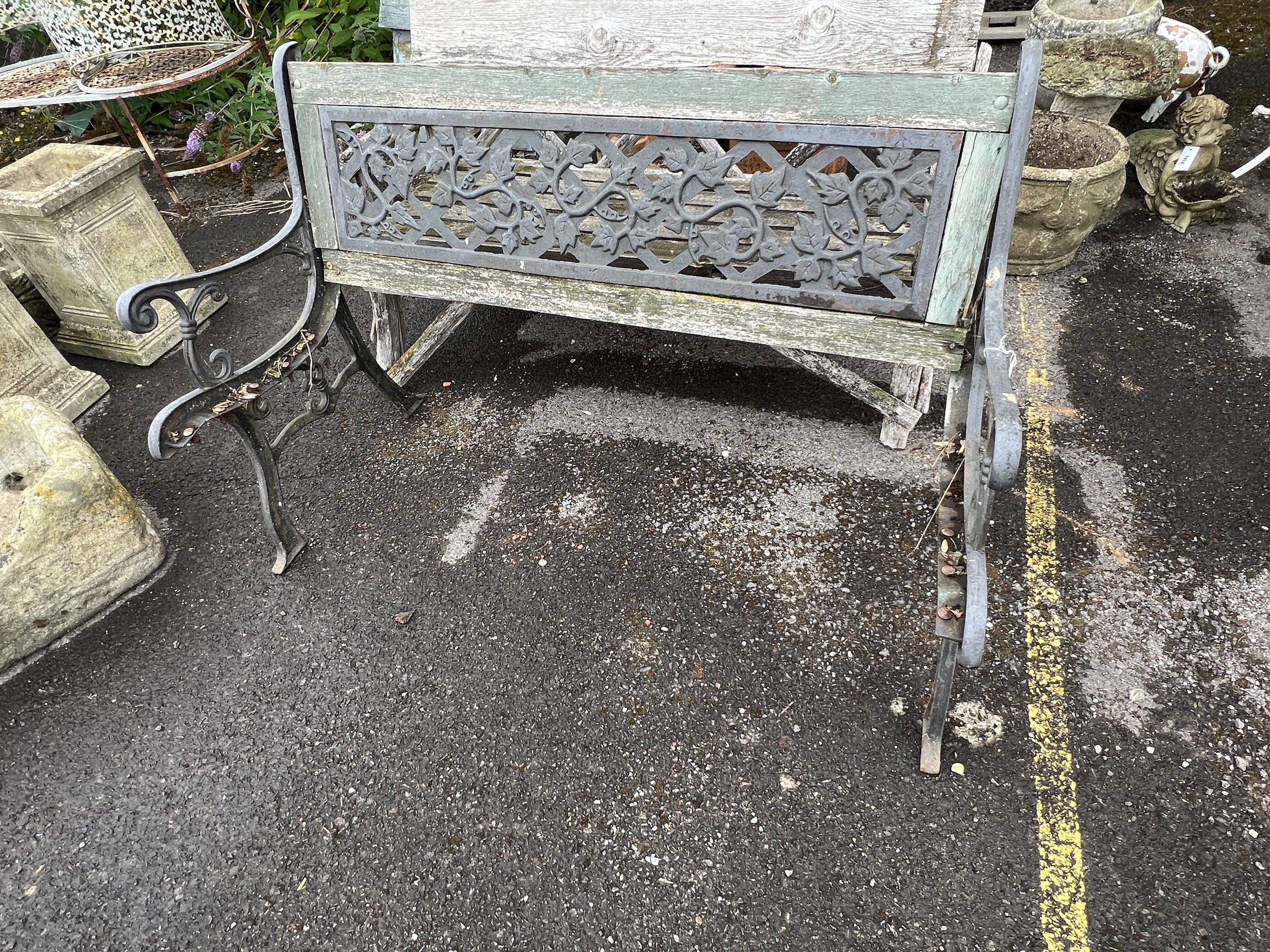 A rustic wooden garden bench, width 133cm, depth 58cm, height 74cm together with an aluminium garden table (in need of restoration)